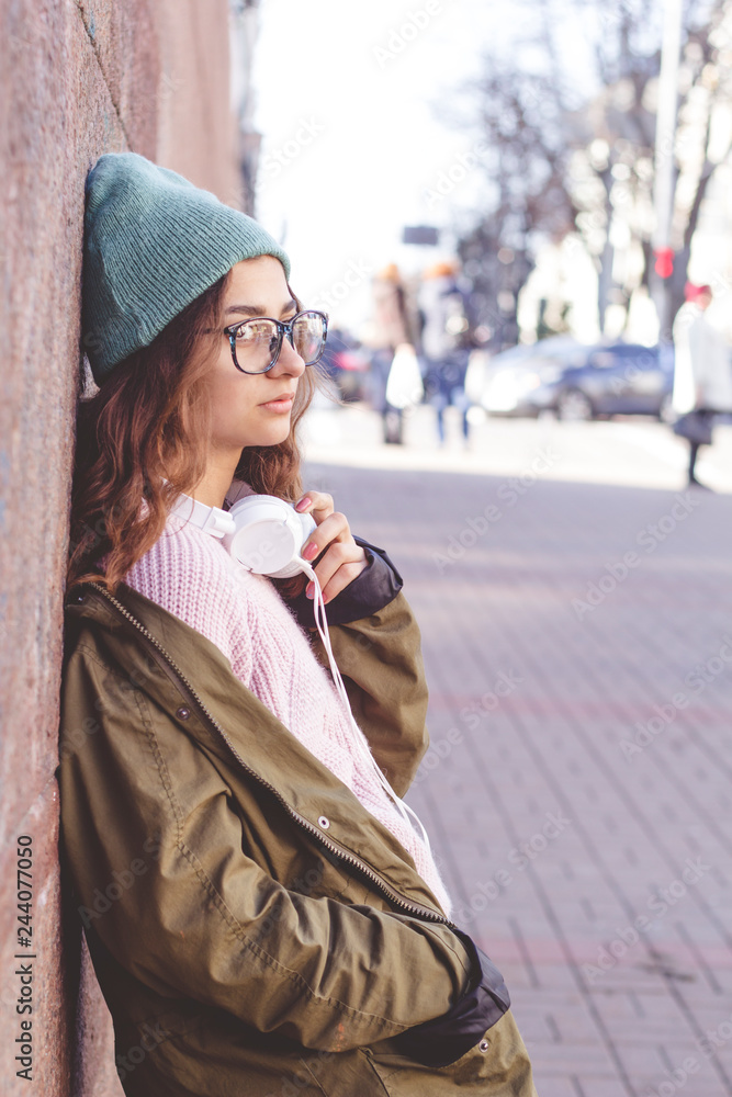 Cute stylish Indian teen girl in glasses on a city street. Cute stylish Indian teen girl in glasses on a city street.
