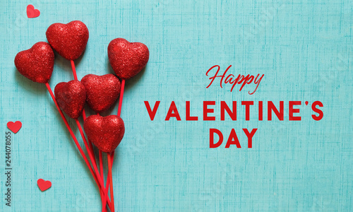 Happy Valentine's Day graphic on blue background with holiday text.  Red hearts arranged for banner full of love.