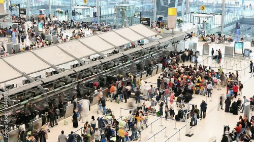 4K Time lapse of crowd passengers at check in counter hall in Suvarnabhumi Airport photo