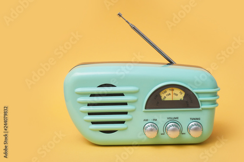 closeup of vintage fifties style radio on yellow background