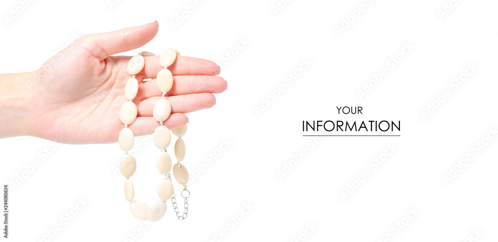 Beads stones ivory in hand pattern on a white background isolation Beads stones ivory in hand pattern on a white background isolation