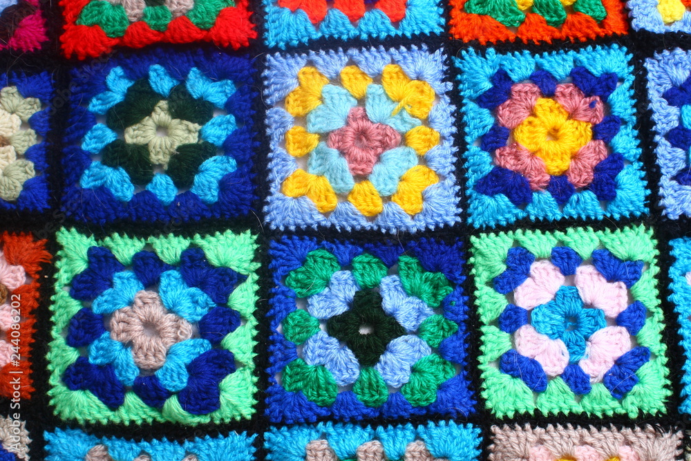 Multicolored handmade plaid of crochet made of granny squares Multicolored handmade plaid of crochet made of granny squares