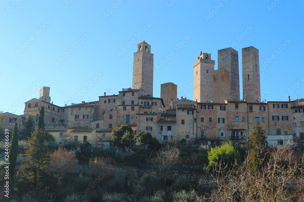 Panoramic view of famous medieval San Gimignano tower at winter sunny day, Tuscany, Italy
