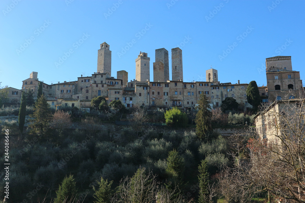 Panoramic view of famous medieval San Gimignano tower at winter sunny day, Tuscany, Italy