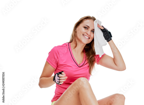 Exhausted happy fitness woman with towel resting after training