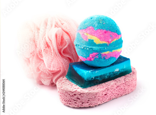 bath salt on a piece of soap and pink washcloths. white background