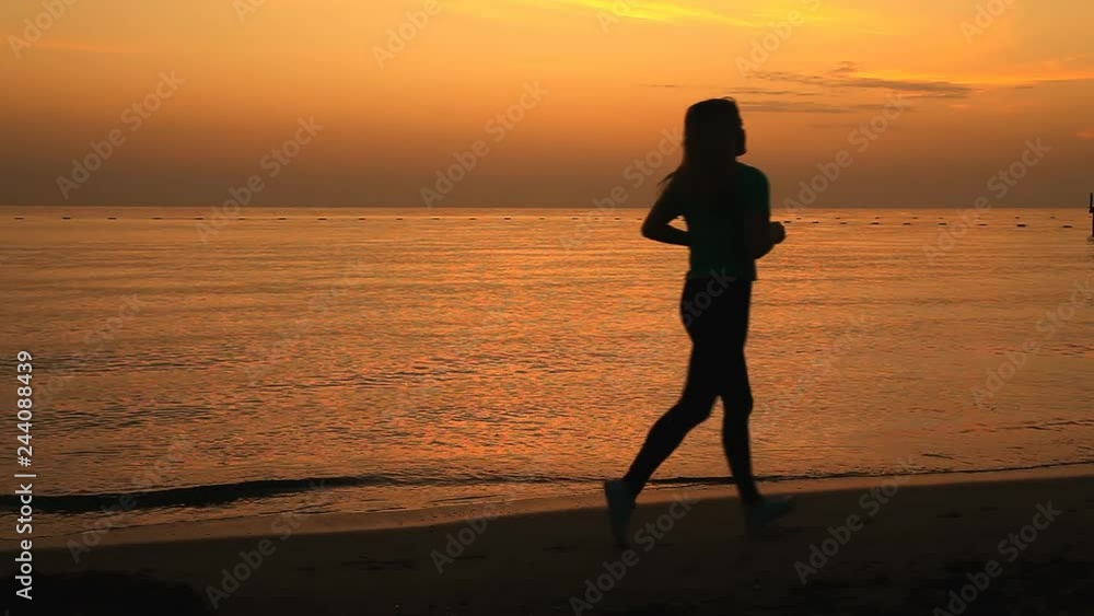 Girl runs at dawn along the seashore Girl runs at dawn along the seashore