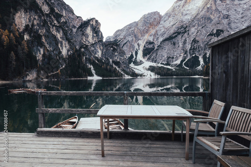Wooden table and chair at the alpine mountain lake