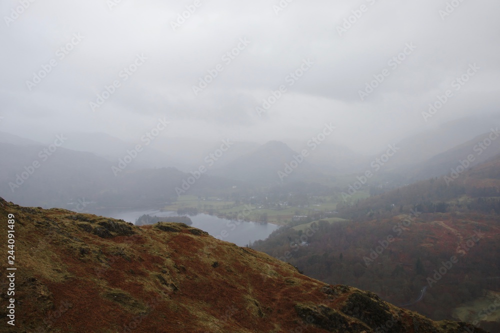 Grasmere in the mist. Lake District, England, autumnal colours on wet spring day