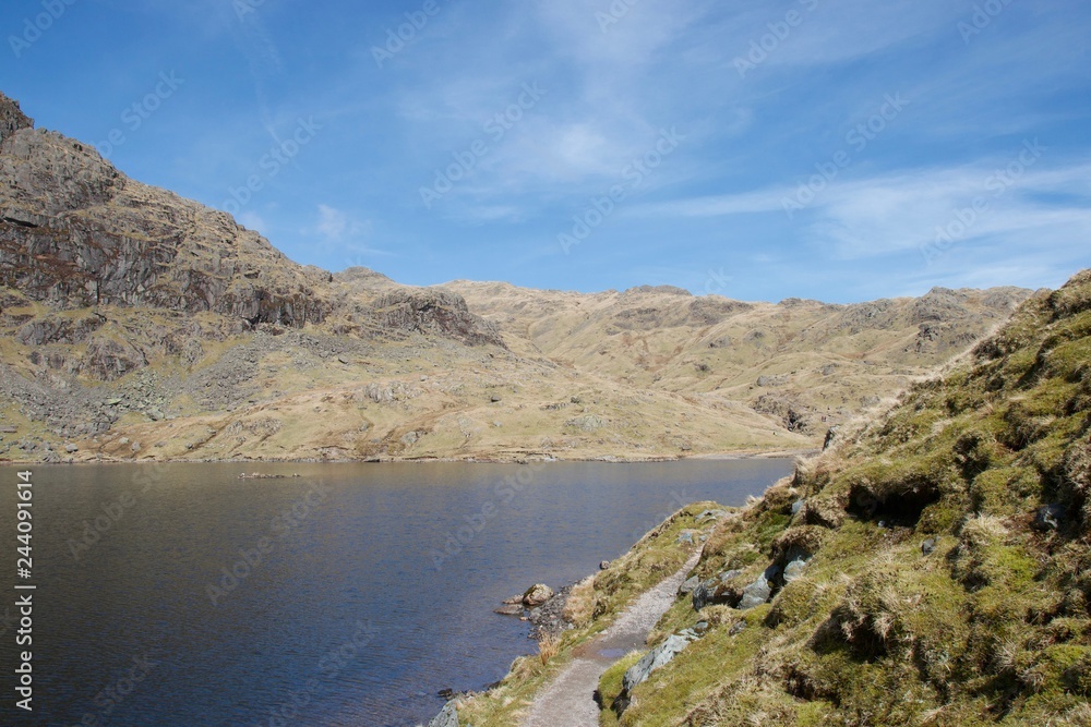 Mountain lake (tarn) and crags in English Lake District
