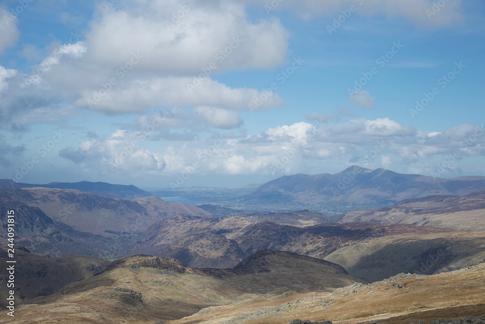 View from mountain in Lake District (Cumbria, UK): lakes and mountains, blue sky and clouds