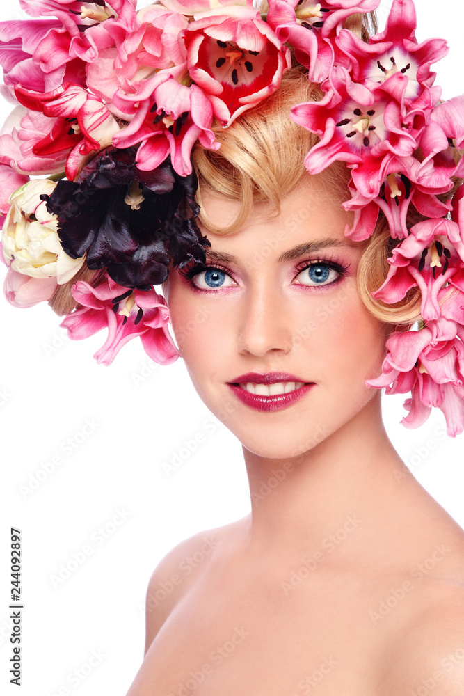 Young beautiful smiling girl with fancy make-up and colorful flowers in her hair