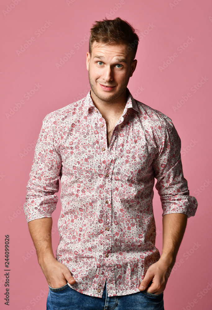 Young successful happy smiling business man in shirt standing posing on pink Young successful happy smiling business man in shirt standing posing on pink