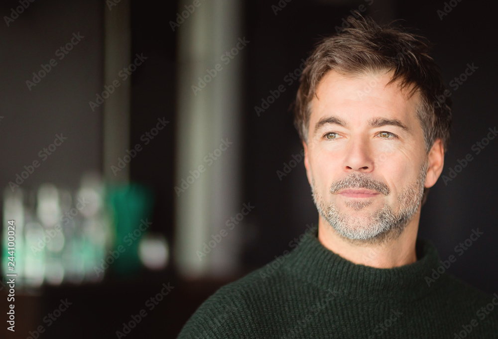 © annawin - A portrait of a middle-aged bearded serious man looking away isolated on a blur background © annawin - A portrait of a middle-aged bearded serious man looking away isolated on a blur background