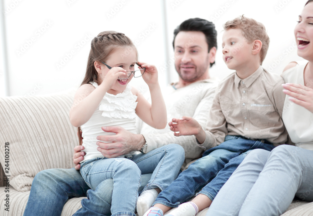loving parents with children sitting on the couch loving parents with children sitting on the couch