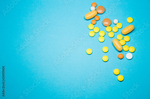 Colored pills on a blue background