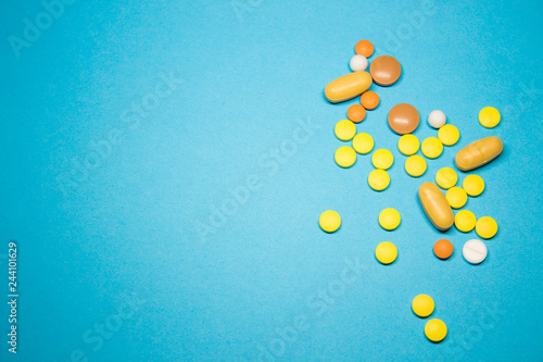 Colored pills on a blue background