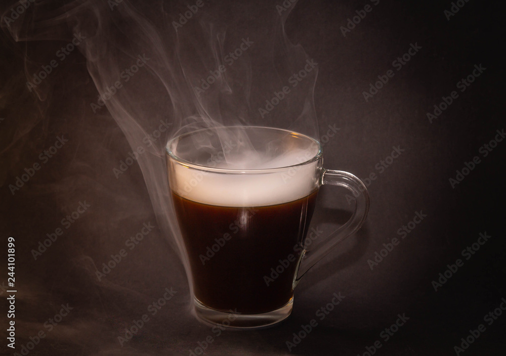 the concept of really hot coffee with cream on a dark isolated background the concept of really hot coffee with cream on a dark isolated background