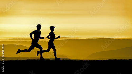 a young couple runs under a golden sunset photo