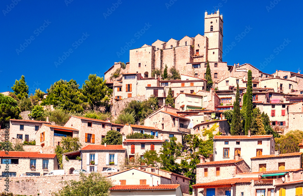 Rural village located on top of a hill in the French Alps on a sunny day.