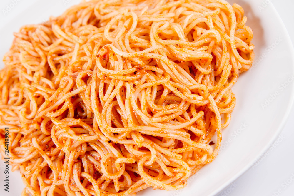 Spaghetti with pesto on a plate on a white background Spaghetti with pesto on a plate on a white background