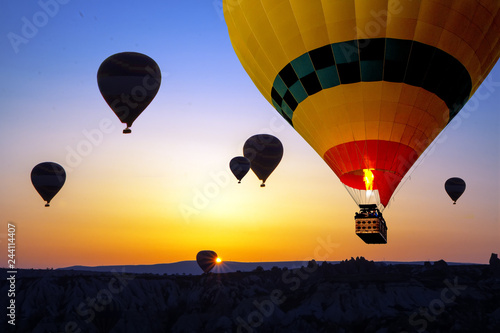 Yellow hot air balloon close-up in the sky of Cappadocia at sunrise