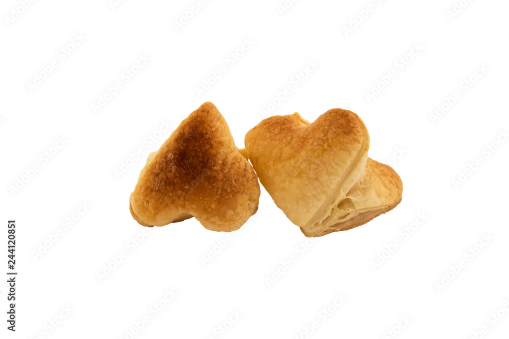 Puff pastry in the shape of a heart. Decoration for Valentine's Day. Isolated on white background. Homemade cookies. Puff pastry in the shape of a heart. Decoration for Valentine's Day. Isolated on white background. Homemade cookies.
