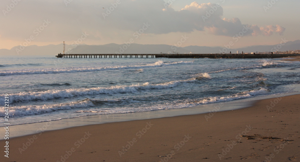 romantic sunset on the beach. straight horizon. the sun goes away. warm colors, yellow, orange and brown romantic sunset on the beach. straight horizon. the sun goes away. warm colors, yellow, orange and brown