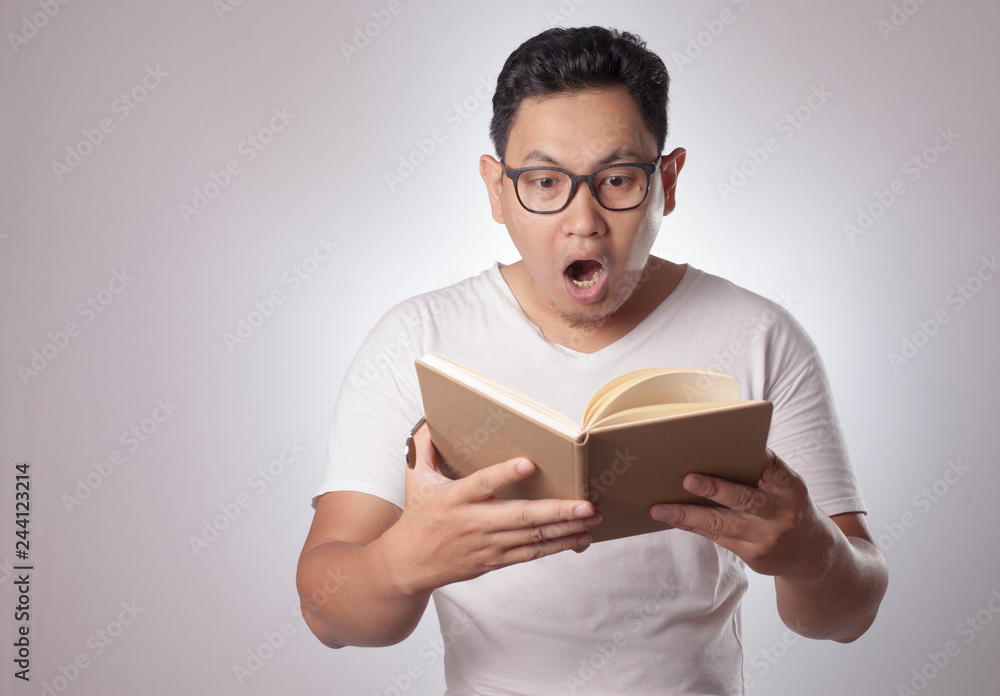 Asian Man Shocked Surprised When Reading a Book Asian Man Shocked Surprised When Reading a Book