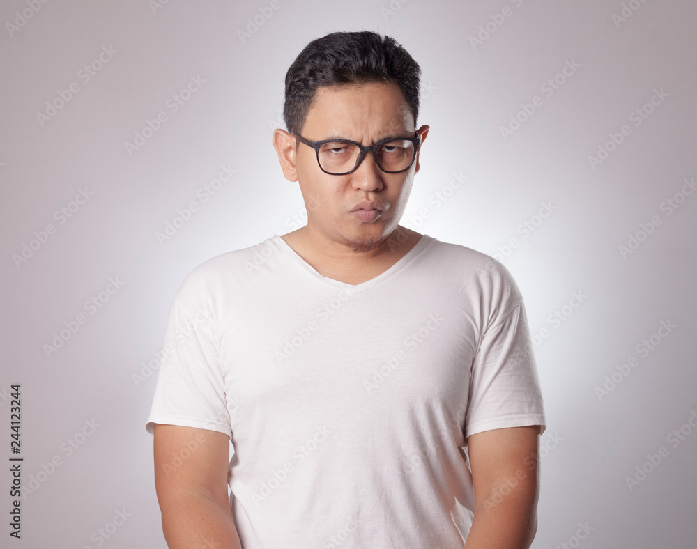 Young Man Staring at Camera with Suspicious Cynical Expression Young Man Staring at Camera with Suspicious Cynical Expression