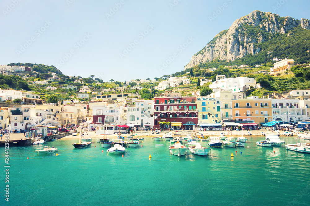 Shops, restaurants, and beaches lining the shore in Capri, Italy 
