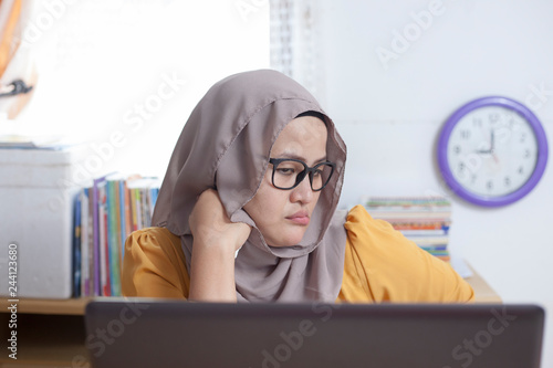 Tired Sleepy Muslim Businesswoman Waiting in Front of Her laptop