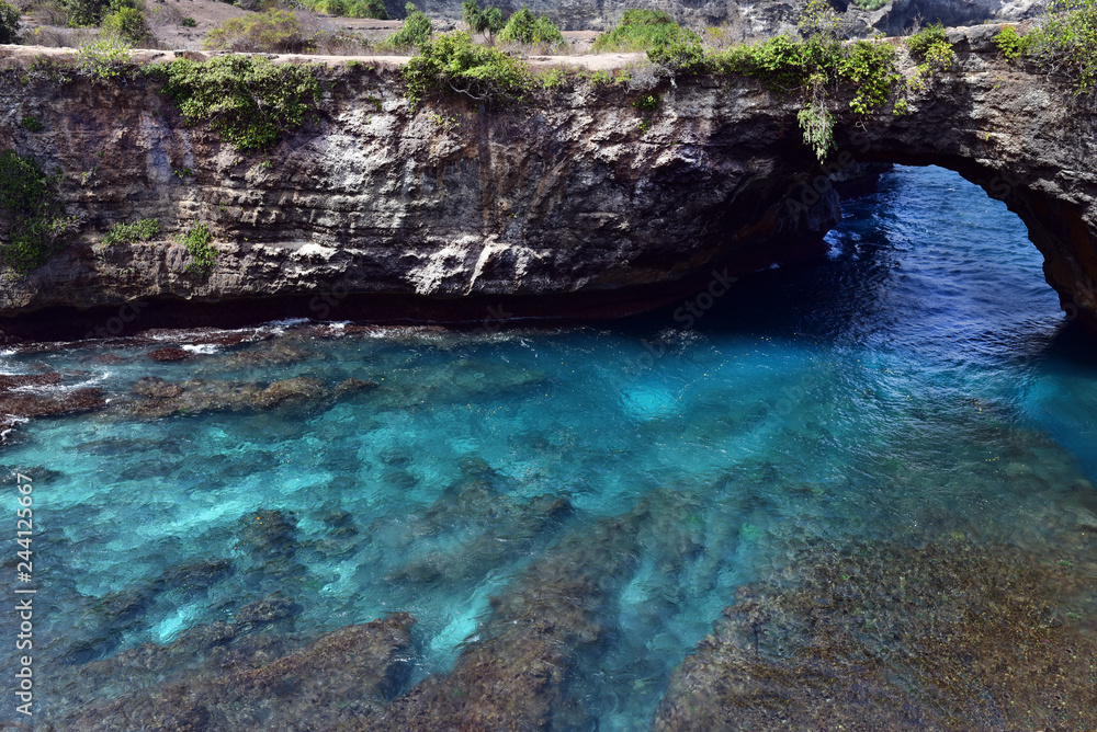 Broken Beach (Pasih Uug) is a scenic coastal formation on the southwestern edge of Nusa Penida island, Indonesia Broken Beach (Pasih Uug) is a scenic coastal formation on the southwestern edge of Nusa Penida island, Indonesia