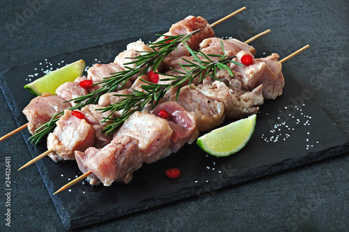 Raw kebabs marinated with rosemary and spices. Fresh juicy meat.