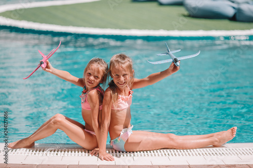 Beautiful little girls having fun near an outdoor pool © travnikovstudio