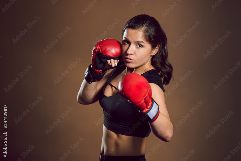 Young athletic girl fighter trains in the gym. Young athletic girl fighter trains in the gym.