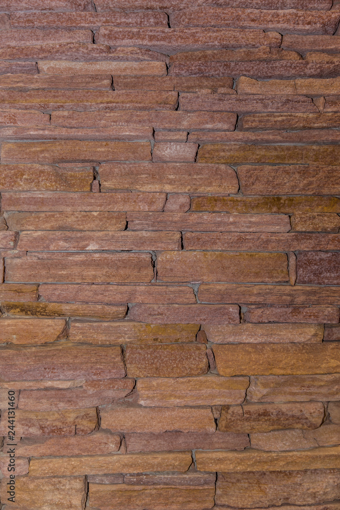 Rustic brown stone wall background texture. Rustic brown stone wall background texture.