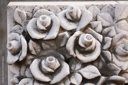 roses carved in stone in old cemetery,detail