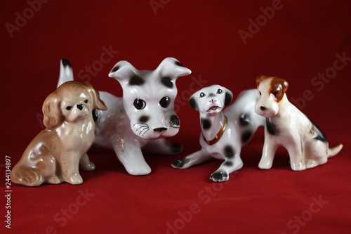 four porcelain dogs  on a red background © Laurenx