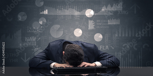 Young businessman sleeping with charts, graphs and reports on the background 