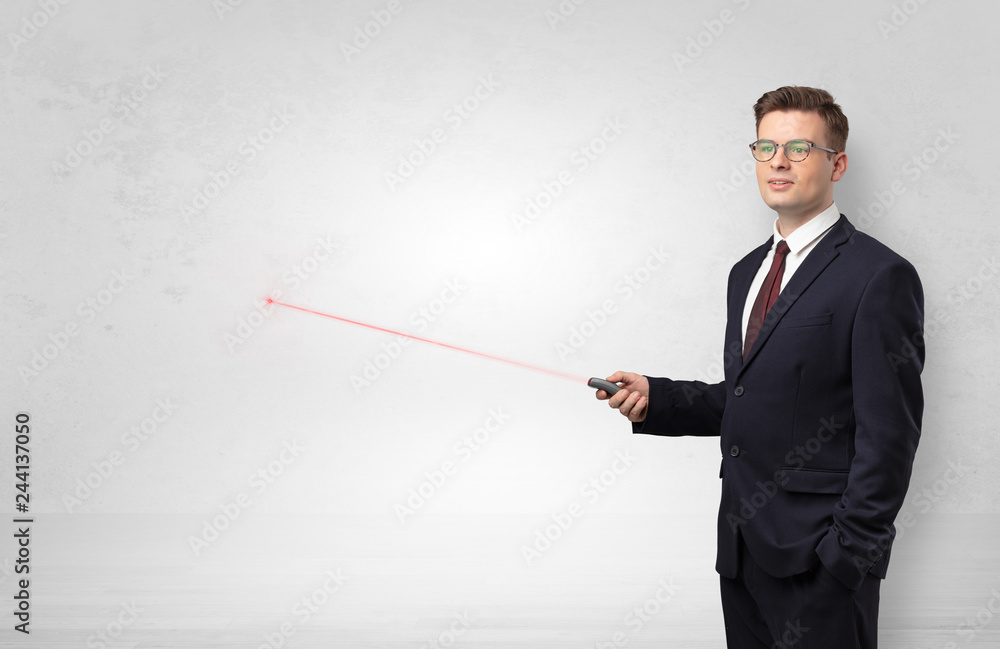 Young businessman with laser pointer and copyspace white wall
Young businessman with laser pointer and copyspace white wall