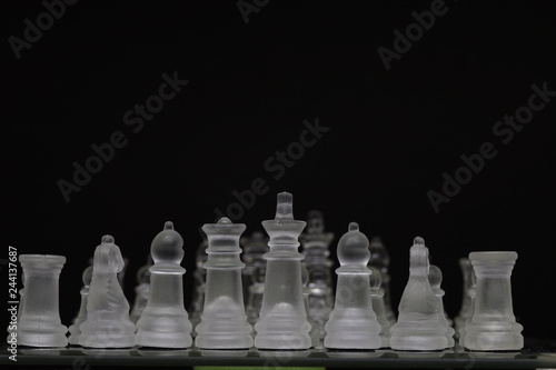 Translucent chess pieces on a chessboard with transparent chess pieces in background