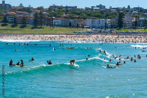 Surfers taking waves on Bondi beach water in Sydney Australia