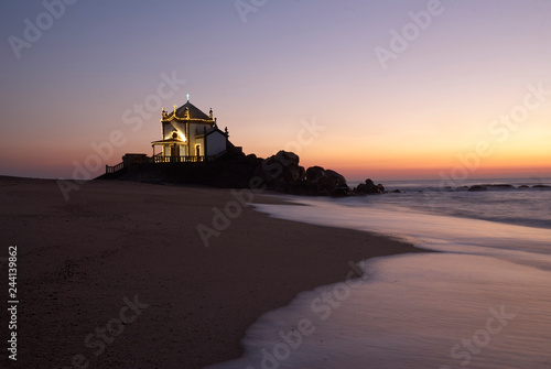 Landscape over the beach of miramar with view to chapel of senhor da Pedra at blue hour © Aldrin