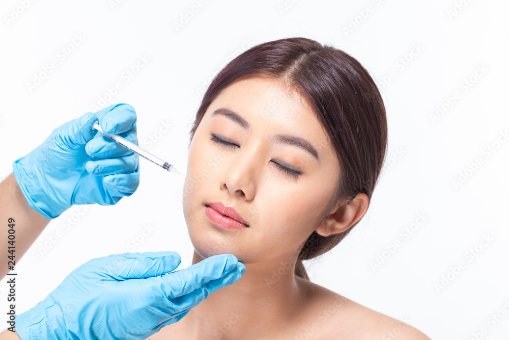 Young asian woman is getting collagen injection into her face. Beauty female face surgery close up portrait. isolated on white background.
