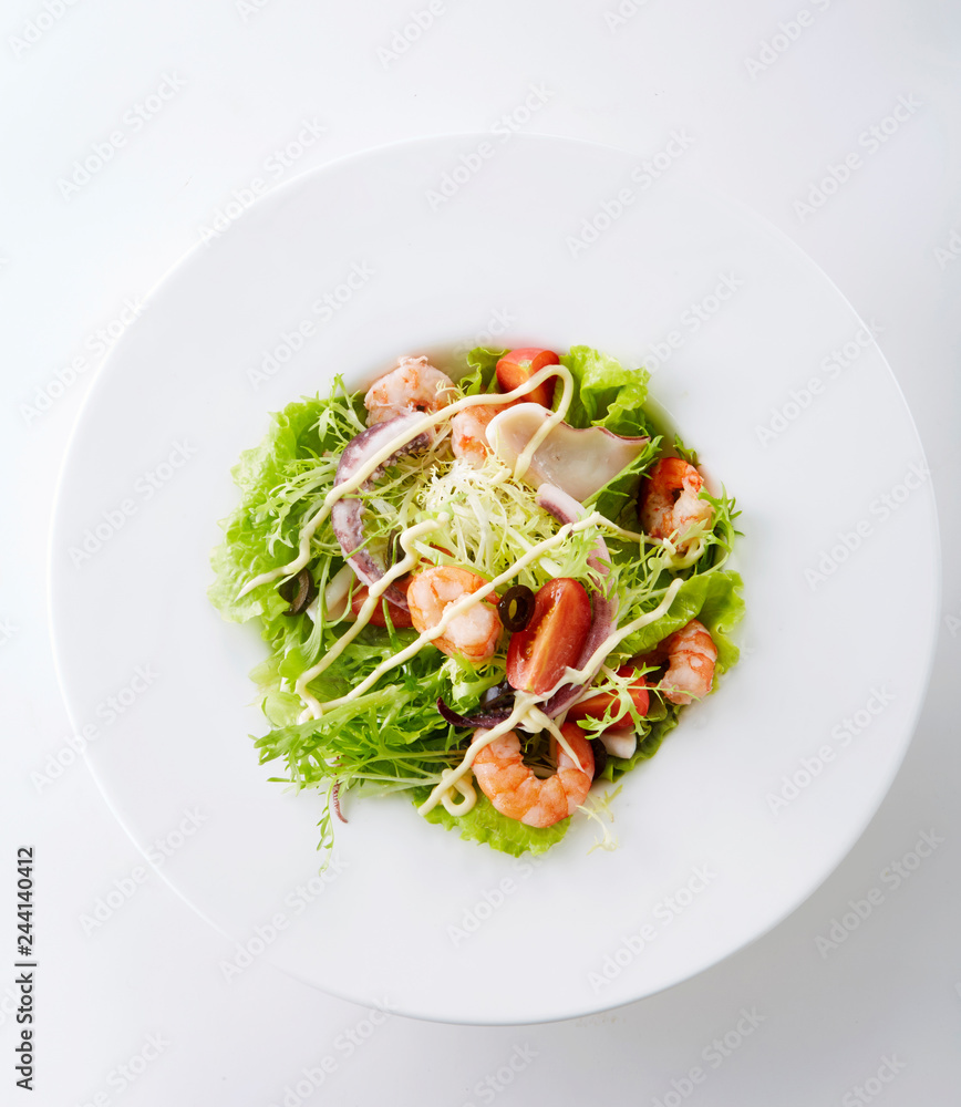 Delicious seafood salad on a white background Delicious seafood salad on a white background