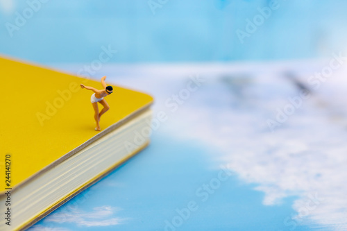 Miniature people: Tourists Sunbathing on the beach. Concept of traveling, business concept.