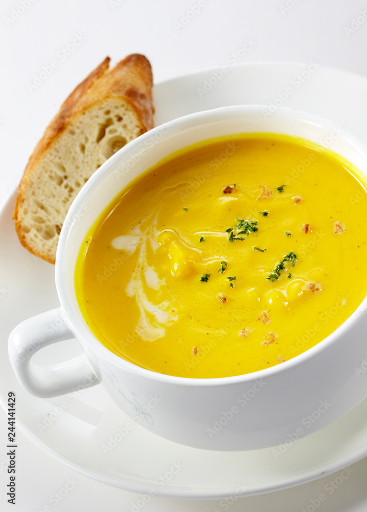 Delicious western-style pumpkin soup on a white background Delicious western-style pumpkin soup on a white background
