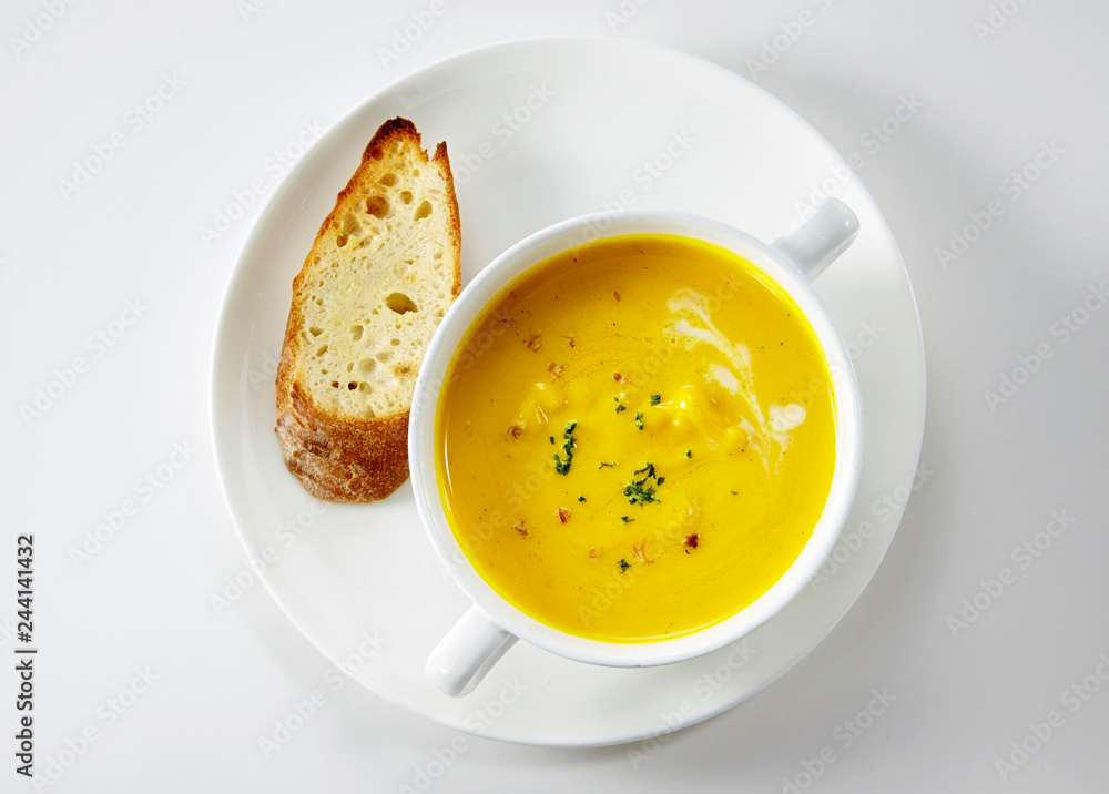 Delicious western-style pumpkin soup on a white background Delicious western-style pumpkin soup on a white background