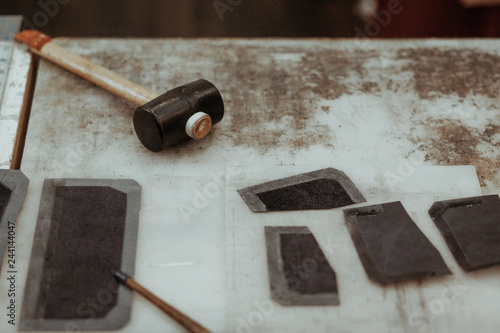 Leather craftmans work desk . Pieces of leather and working tools on a work table. Leather craft. photo